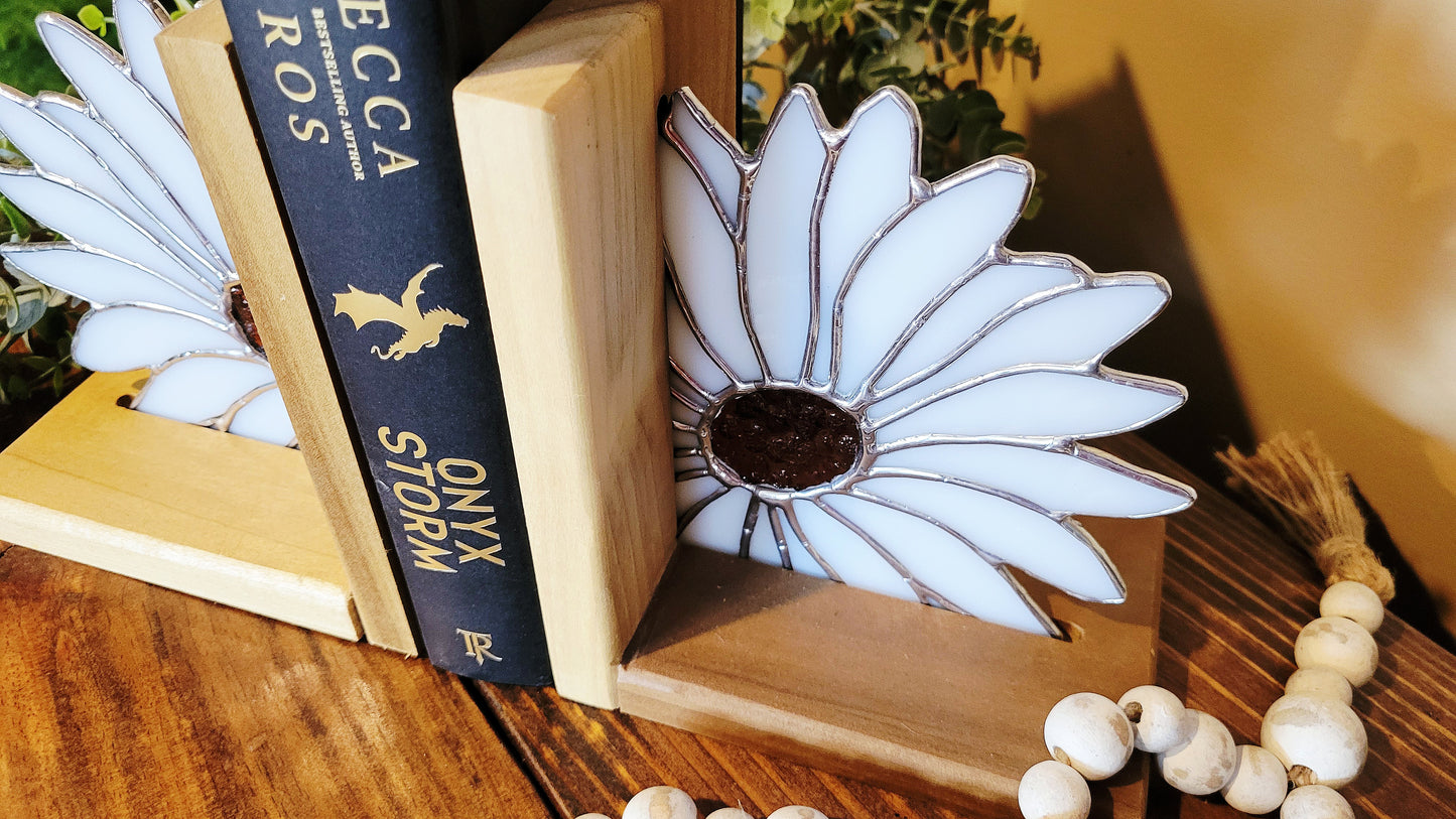 Side angle of stained glass daisy bookend mounted in solid wood base supporting books